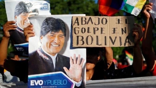 Supporters of Bolivia's ousted President Evo Morales hold a placard that reads &quot;Down with the coup in Bolivia&quot; as they gather outside the U.S. embassy in Buenos Aires to protest against the U.S. government, in Buenos Aires, Argentina November 22, 2019