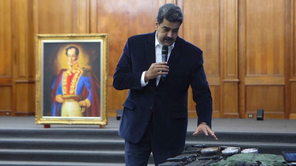 Venezuela's President Nicolas Maduro shows military equipment during a meeting with the armed forces